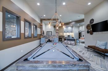 Game room with pool table and lounge seating